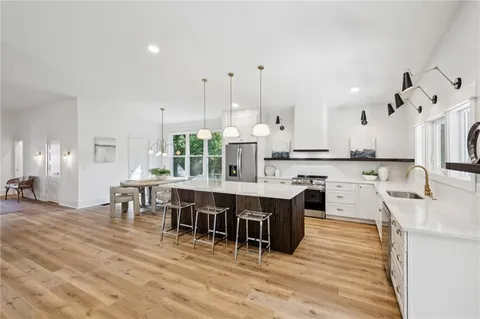 a large kitchen with a table and chairs