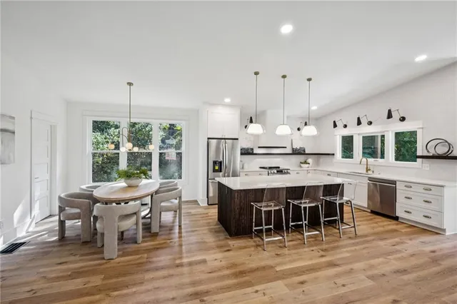 a kitchen with a sink a stove and a window