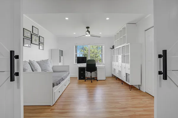 a view of a workspace with furniture and a window