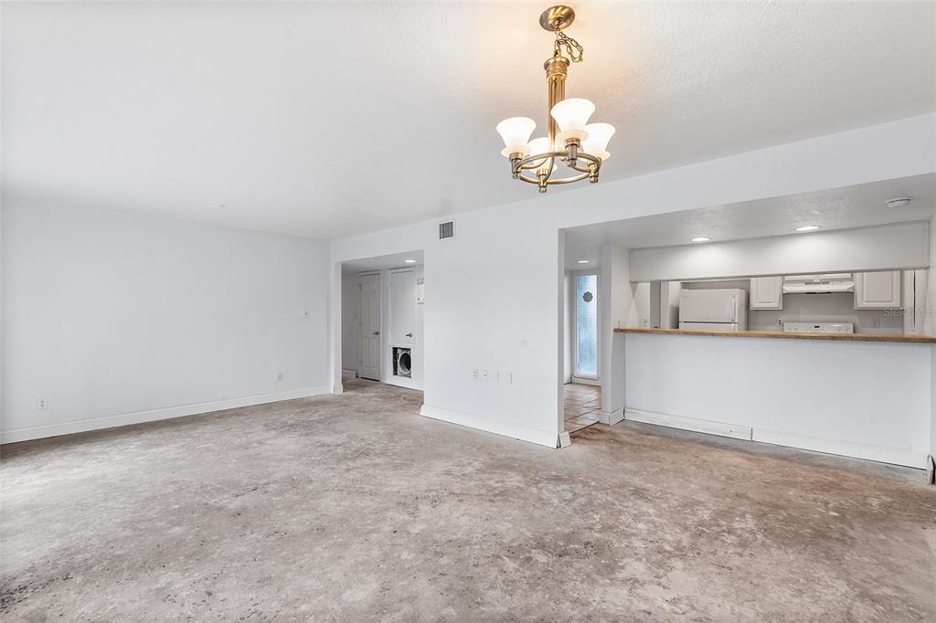 2070 Corner Lake, Unit AB Haines City, FL 33844 - Photo 12 of 31 an empty room with a chandelier