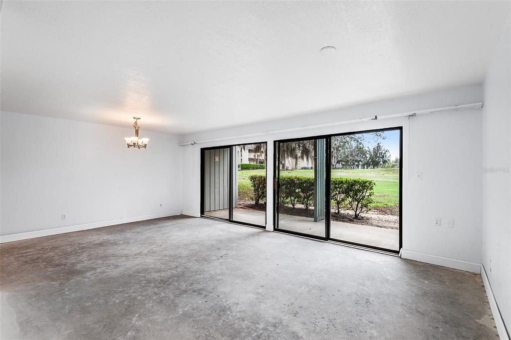 2070 Corner Lake, Unit AB Haines City, FL 33844 - Photo 15 of 31 wooden floor in an empty room with a window