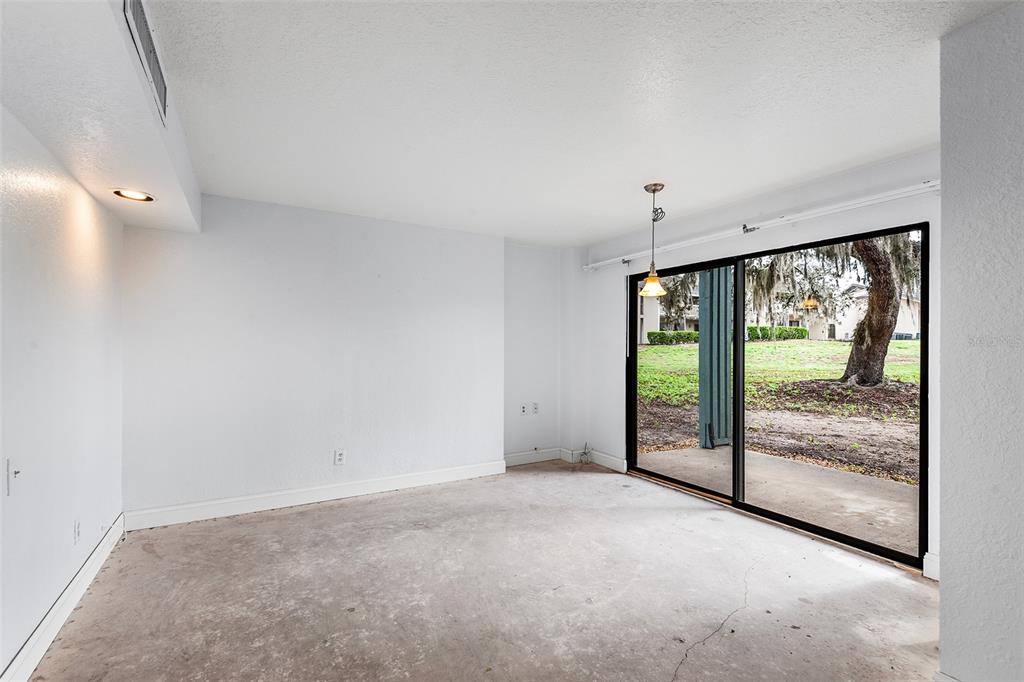 2070 Corner Lake, Unit AB Haines City, FL 33844 - Photo 18 of 31 a view of an empty room with a sliding door