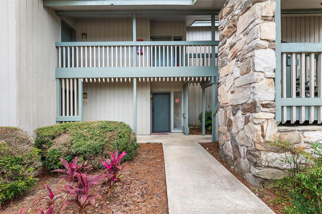2070 Corner Lake, Unit AB Haines City, FL 33844 - Photo 2 of 31 a front view of a house with a garden