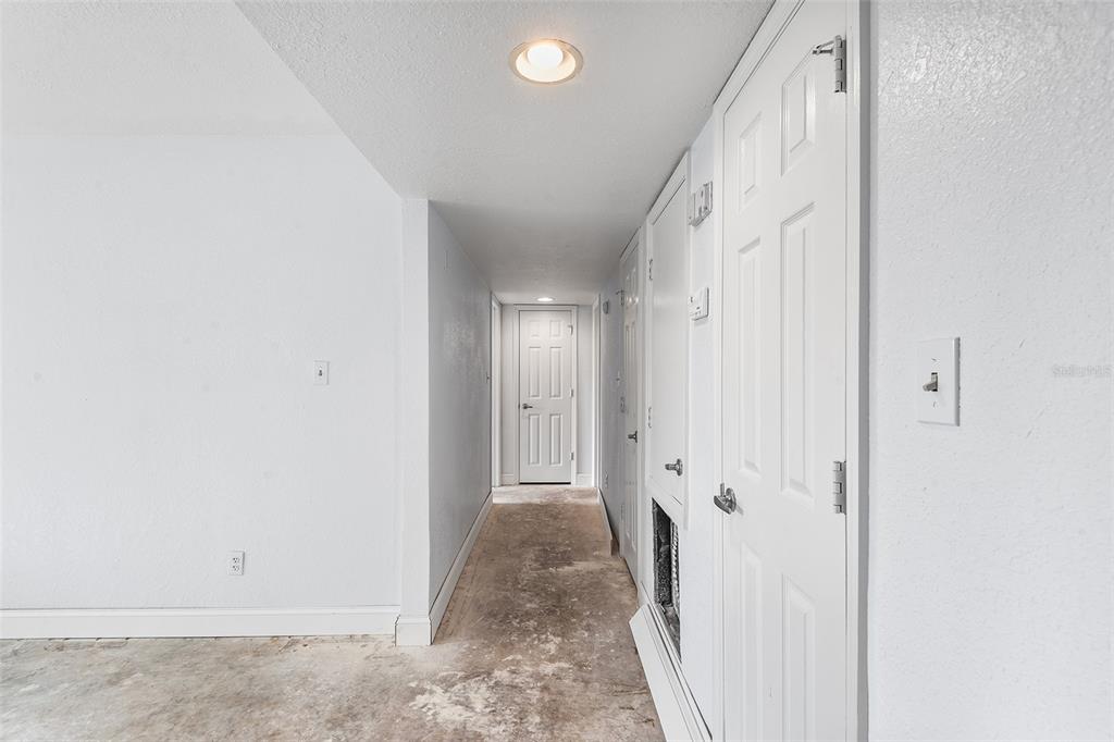 2070 Corner Lake, Unit AB Haines City, FL 33844 - Photo 22 of 31 a view of a hallway with wooden shelves