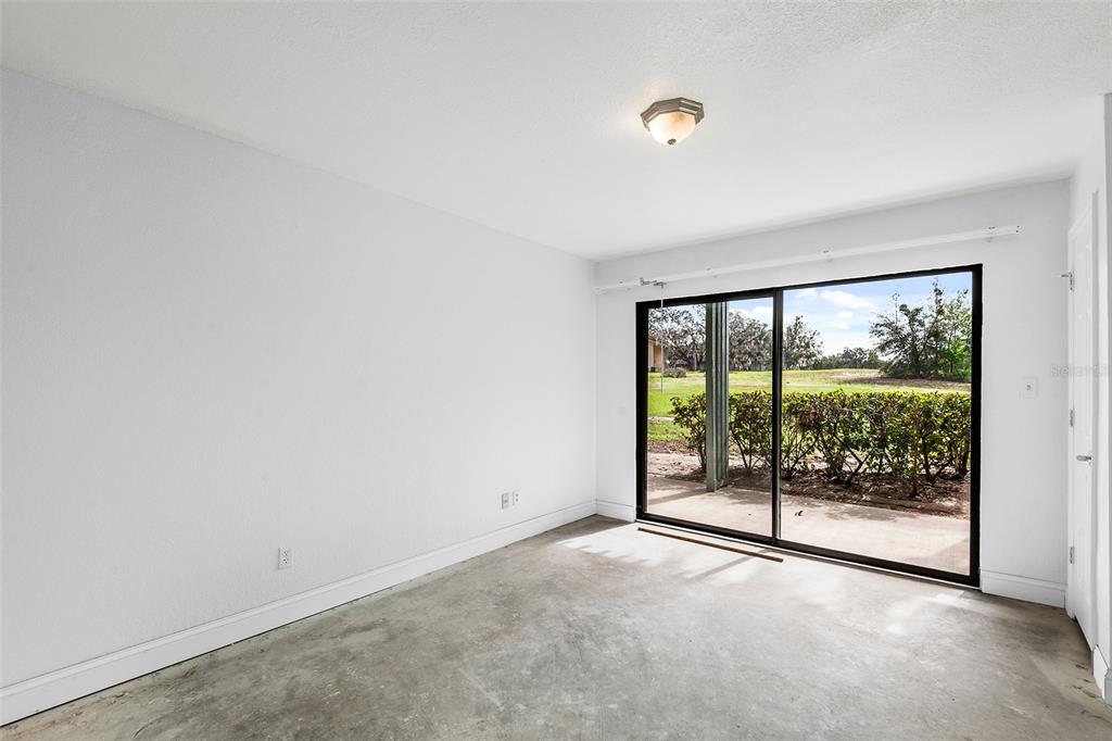 2070 Corner Lake, Unit AB Haines City, FL 33844 - Photo 25 of 31 an empty room with wooden floor and sliding door