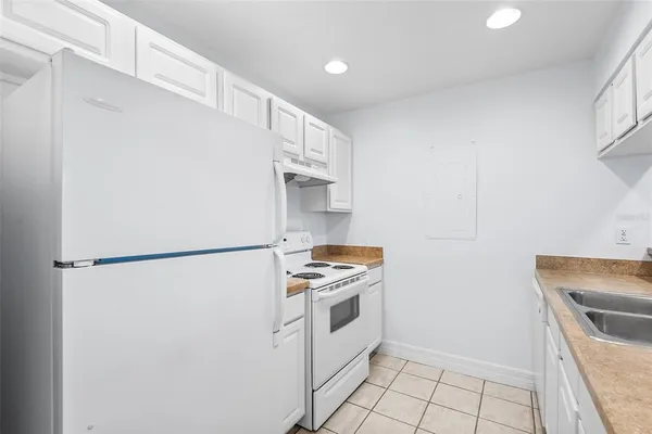 a kitchen with a refrigerator and a stove