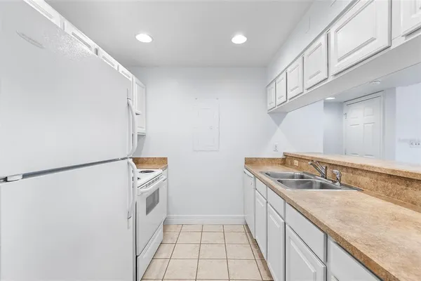 a kitchen with a sink and a refrigerator