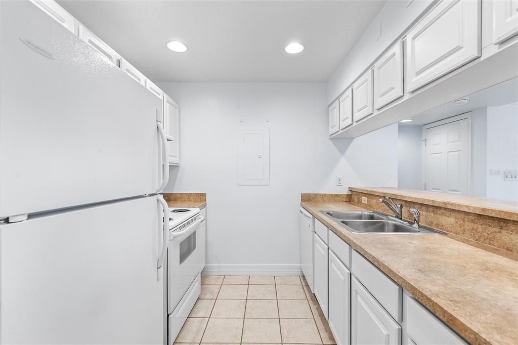 2070 Corner Lake, Unit AB Haines City, FL 33844 - Photo 6 of 31 a kitchen with a sink and a refrigerator