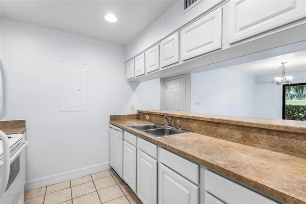a view of a kitchen with granite countertop white cabinets and a granite counter tops