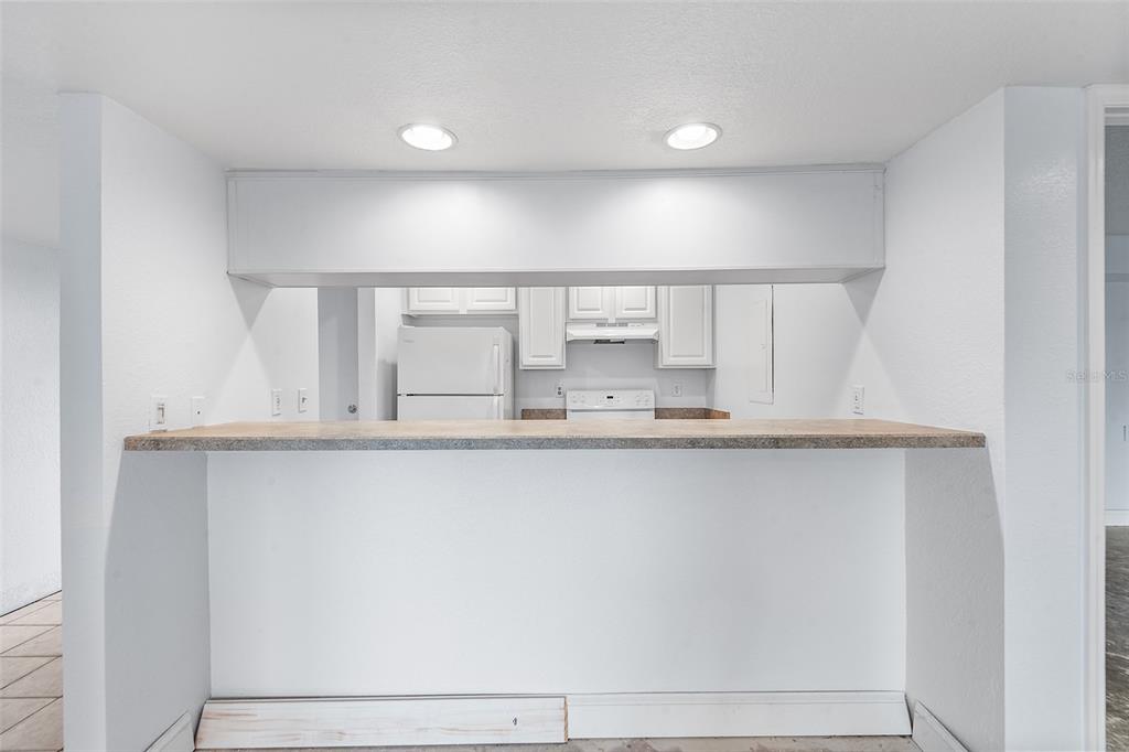 2070 Corner Lake, Unit AB Haines City, FL 33844 - Photo 8 of 31 a kitchen with granite countertop a white sink and cabinets