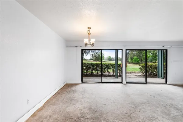 an empty room with sliding door and balcony