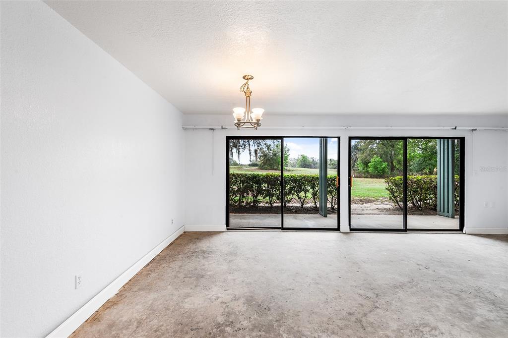 2070 Corner Lake, Unit AB Haines City, FL 33844 - Photo 10 of 31 an empty room with sliding door and balcony