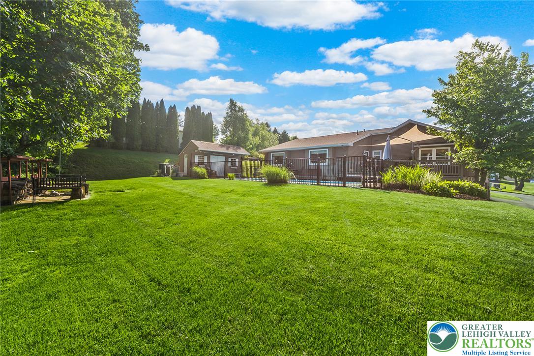 540 Briar Road Pen Argyl, PA 18072 - Photo 50 of 66 A spacious, verdant yard invites outdoor activities, complemented by a private deck and a shimmering pool.