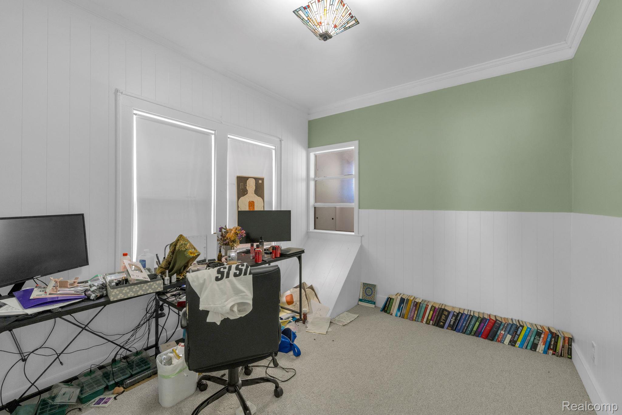 7631 Maple Street Dearborn, MI 48126 - Photo 25 of 48 Wall-to-wall carpeting with beadboard wainscoting and a pastel green wall