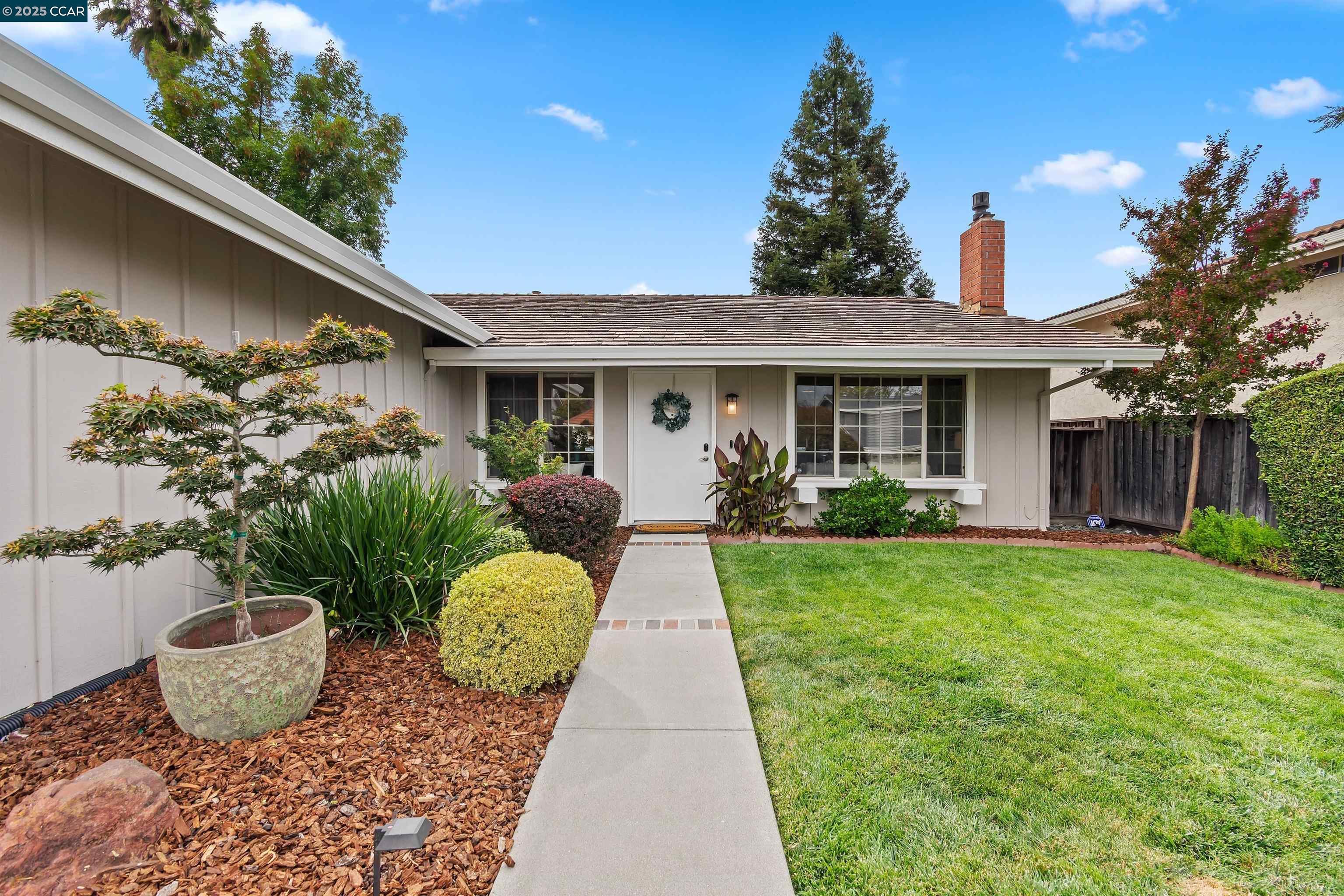 a front view of a house with garden
