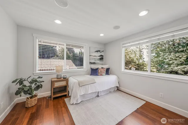 a bedroom with a large bed and a large window
