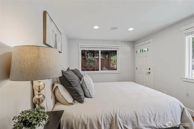 a bedroom with a bed and a large mirror