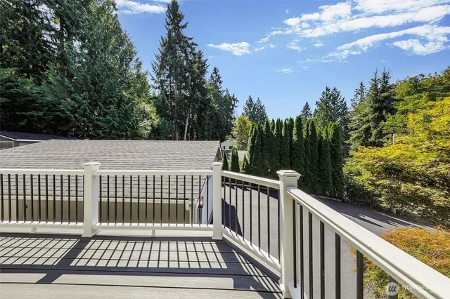 a view of balcony with wooden floor and fence
