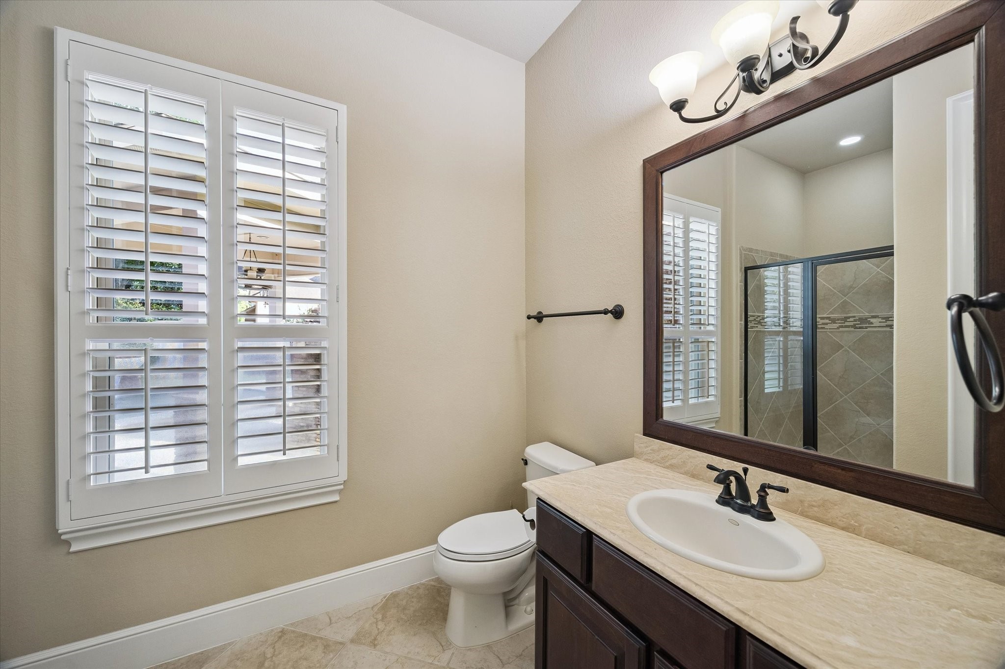 35 North Fremont Ridge Loop Spring, TX 77389 - Photo 11 of 37 Designed with comfort in mind, the private en-suite bath complements the guest suite with quality finishes, generous counter space, and a welcoming atmosphere for family and visitors alike.