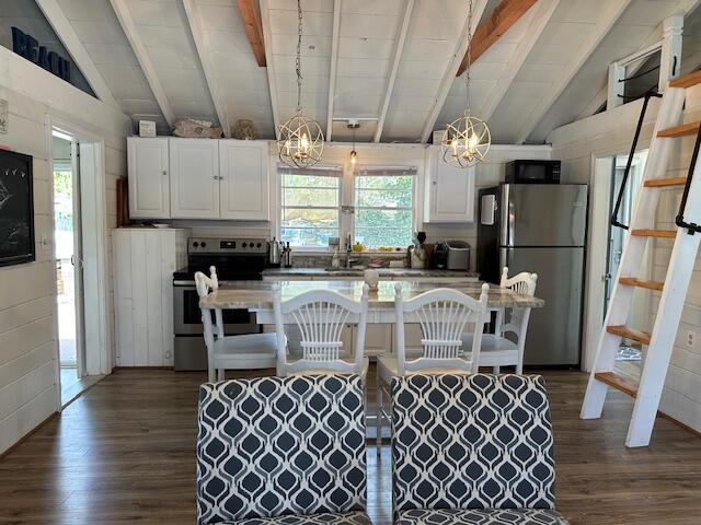 242 Old Wharf Road, Unit F7 Dennis Port, MA 02639 - Photo 13 of 48 a kitchen with stainless steel appliances a sink a stove a refrigerator and cabinets