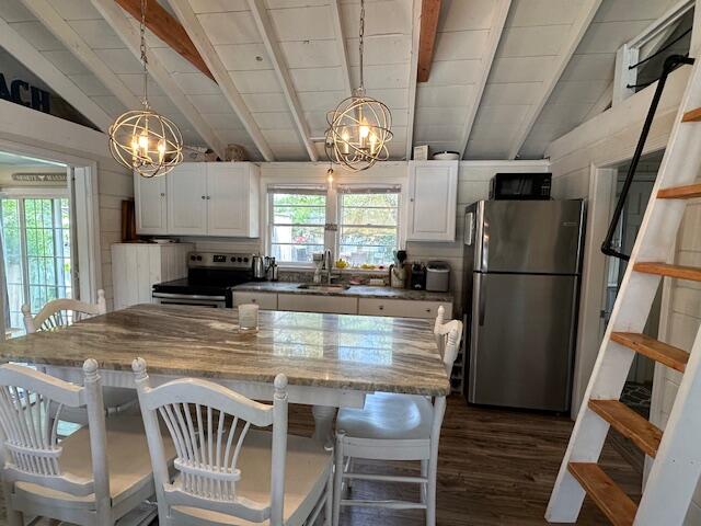 242 Old Wharf Road, Unit F7 Dennis Port, MA 02639 - Photo 14 of 48 a kitchen with stainless steel appliances granite countertop a refrigerator a stove a sink a dining table and chairs