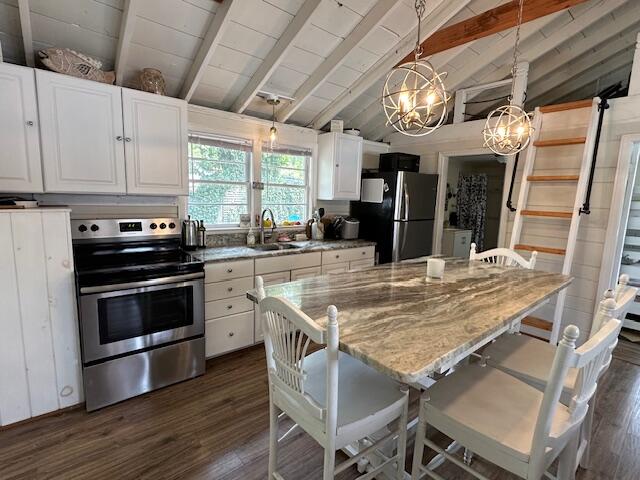 242 Old Wharf Road, Unit F7 Dennis Port, MA 02639 - Photo 16 of 48 a kitchen with stainless steel appliances granite countertop a stove top oven a sink and cabinets