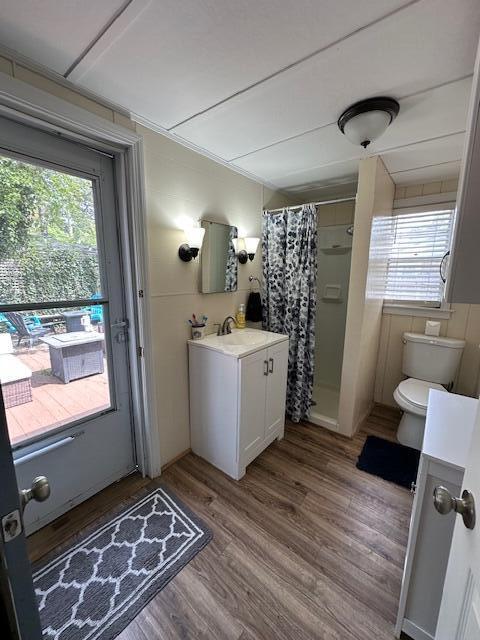 242 Old Wharf Road, Unit F7 Dennis Port, MA 02639 - Photo 30 of 48 a view of a kitchen with fridge and wooden floor