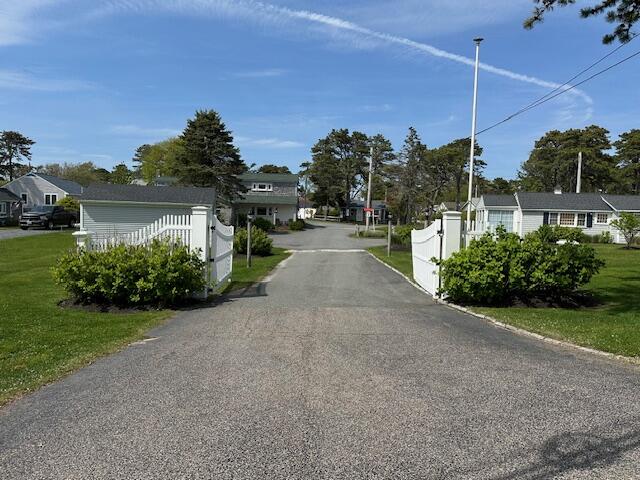 242 Old Wharf Road, Unit F7 Dennis Port, MA 02639 - Photo 3 of 48 a view of a house with a yard and potted plants