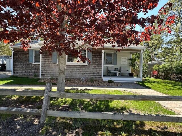 242 Old Wharf Road, Unit F7 Dennis Port, MA 02639 - Photo 4 of 48 a view of a house with a yard potted plants and large tree