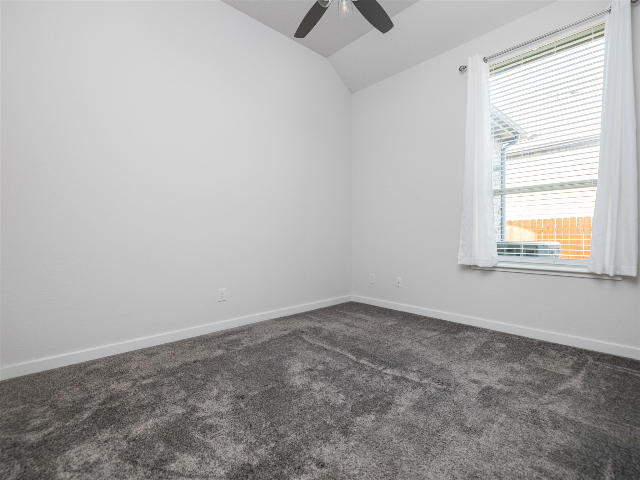 606 Spinnaker Loop Kyle, TX 78640 - Photo 19 of 37 Comfortable bedroom offers soft carpeting and a window with natural light.