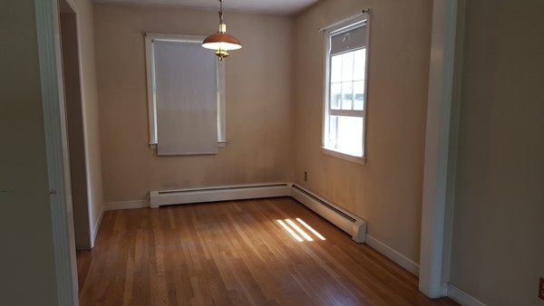 28 Hampstead Road Salem, NH 03079 - Photo 4 of 4 a view of empty room with wooden floor and fan