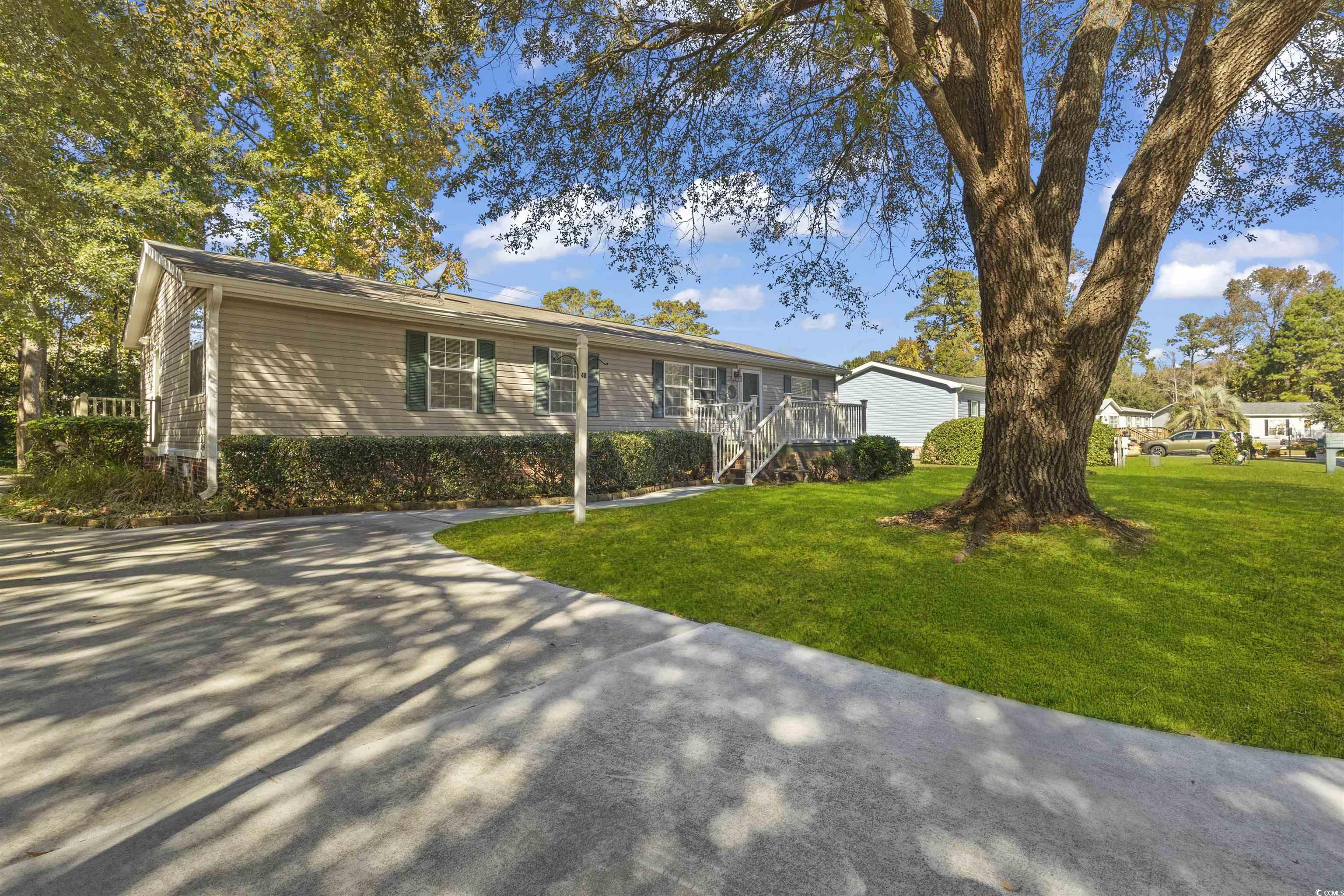 Ranch-style house with a front yard and stairs