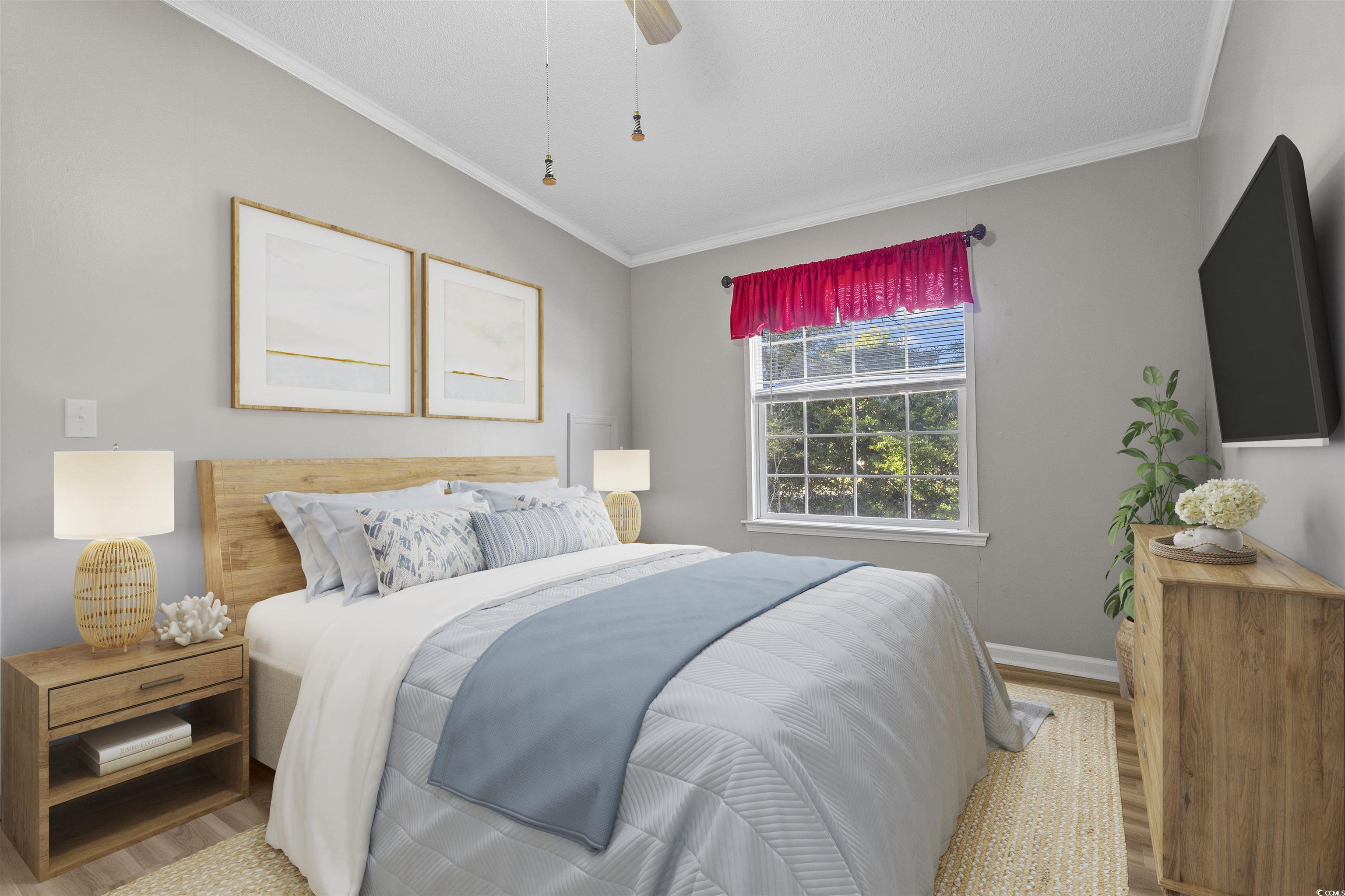 48 Talon Circle Murrells Inlet, SC 29576 - Photo 13 of 28 Bedroom featuring crown molding, wood finished floors, and a ceiling fan