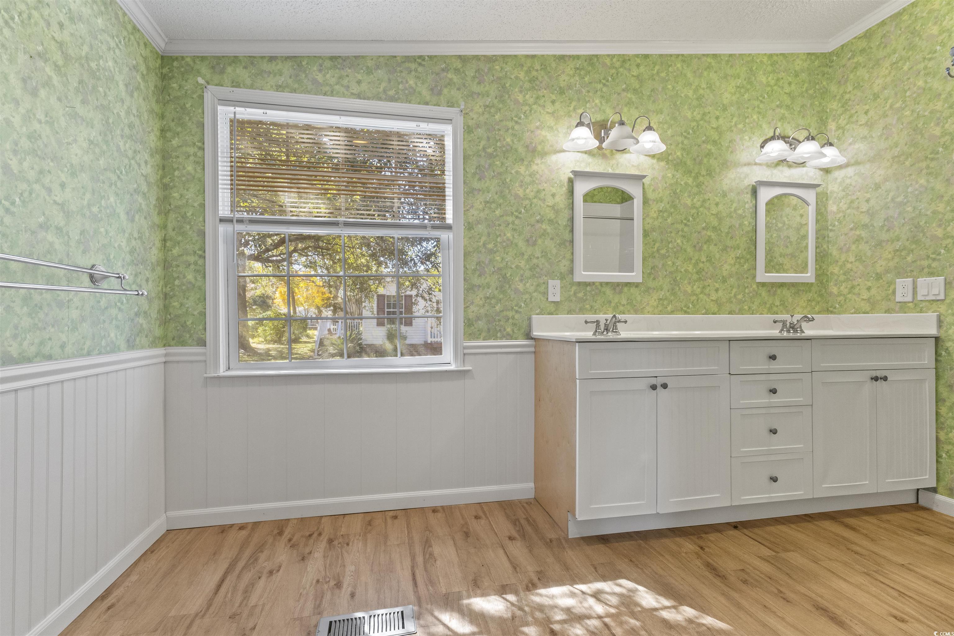 48 Talon Circle Murrells Inlet, SC 29576 - Photo 18 of 28 Bathroom featuring wallpapered walls, ornamental molding, double vanity, a textured ceiling, and light wood-style floors