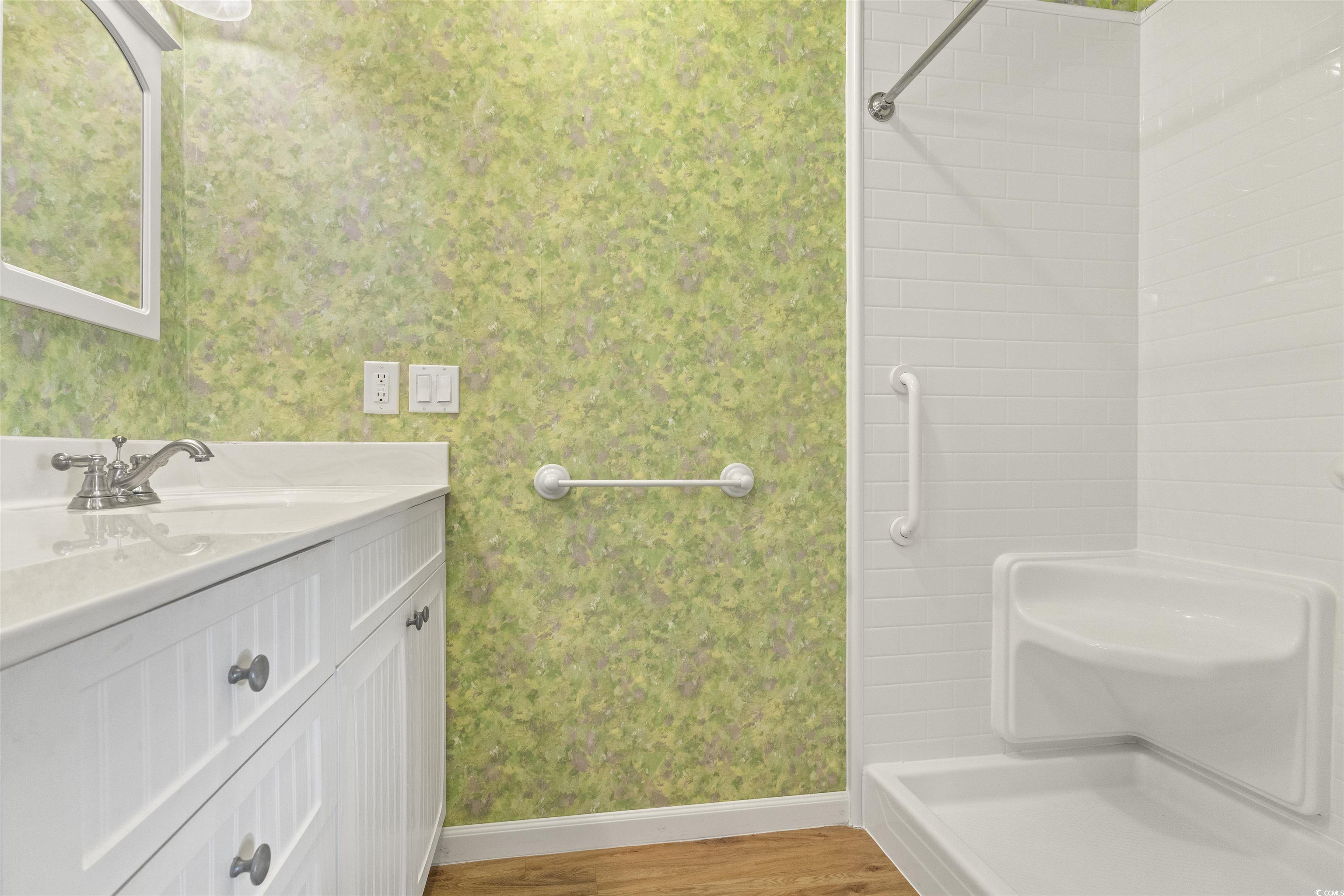 48 Talon Circle Murrells Inlet, SC 29576 - Photo 19 of 28 Bathroom with vanity, wallpapered walls, a shower, and light wood finished floors