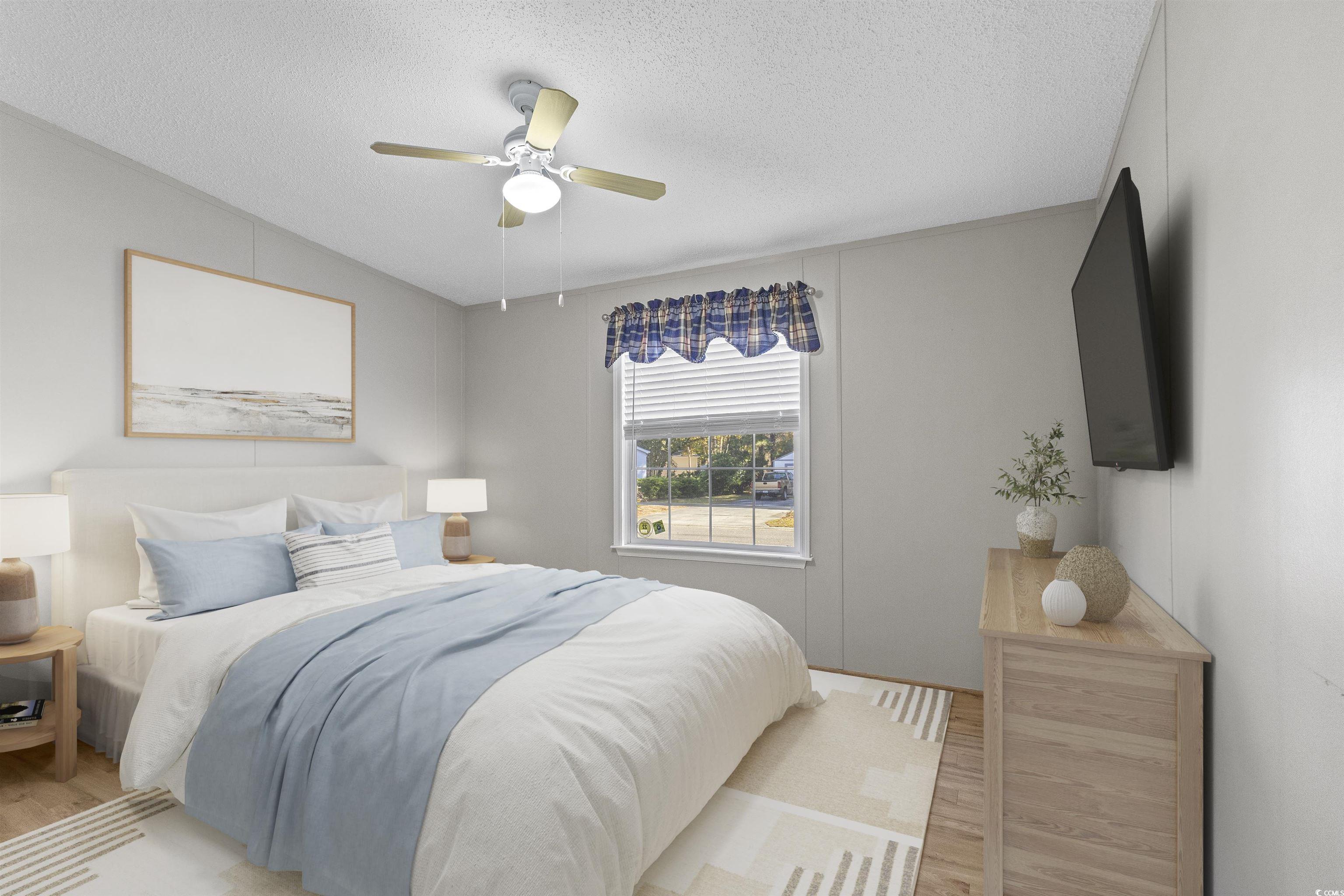 48 Talon Circle Murrells Inlet, SC 29576 - Photo 20 of 28 Bedroom featuring a textured ceiling, wood finished floors, and a ceiling fan