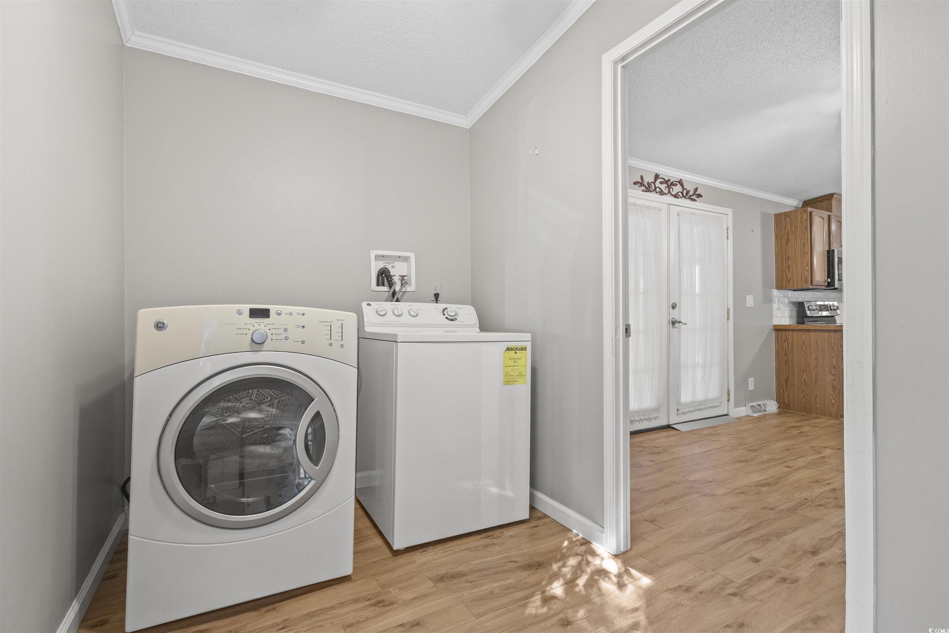 48 Talon Circle Murrells Inlet, SC 29576 - Photo 25 of 28 Washroom featuring light wood finished floors, washer and dryer, ornamental molding, and a textured ceiling