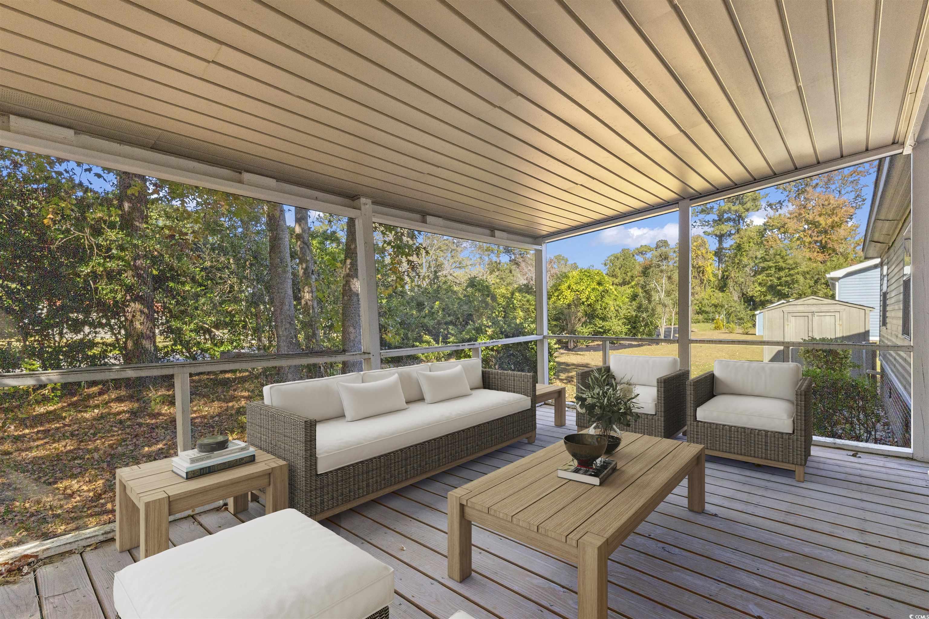48 Talon Circle Murrells Inlet, SC 29576 - Photo 26 of 28 Sunroom with an outdoor hangout area, a deck, healthy amount of natural light, and view of wooded area