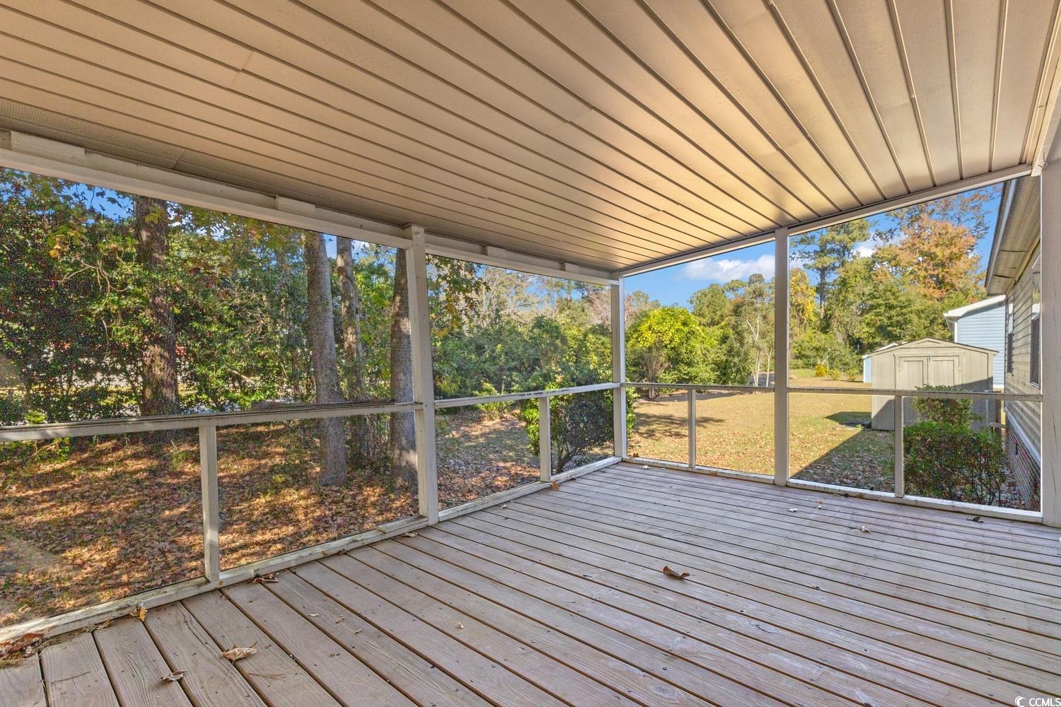 48 Talon Circle Murrells Inlet, SC 29576 - Photo 27 of 28 Unfurnished sunroom with a deck and view of wooded area