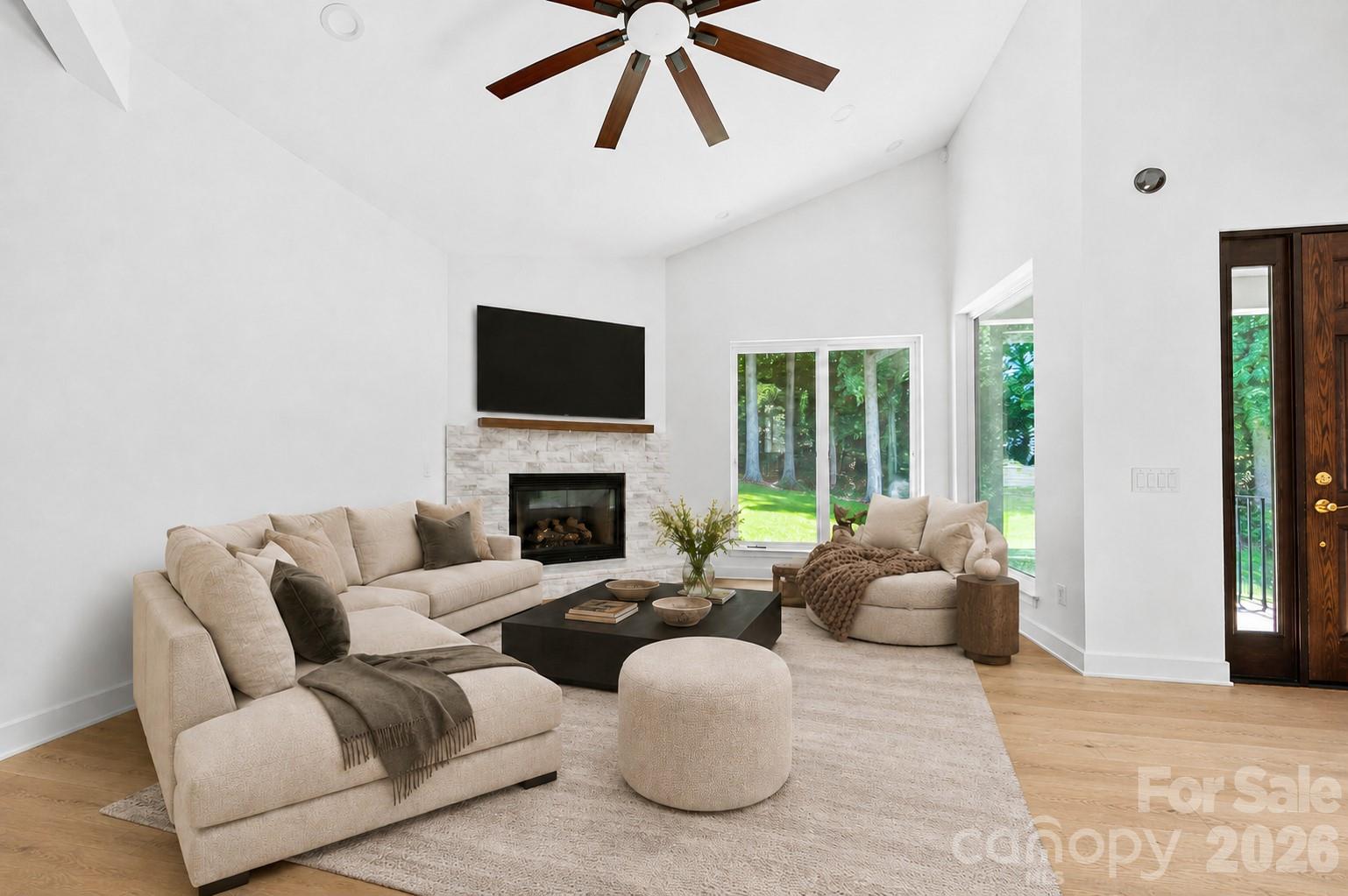 23 Early Spring Way Leicester, NC 28748 - Photo 6 of 33 a living room with furniture a large window and a fireplace