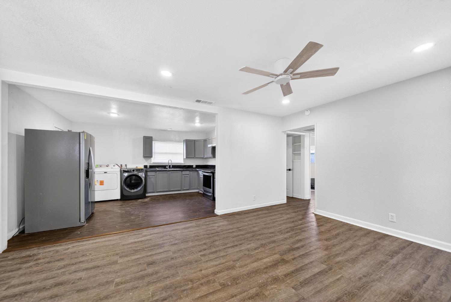 622 South 11th Street Fresno, CA 93702 - Photo 17 of 37 a view of a livingroom with a ceiling fan wooden floor and a ceiling fan