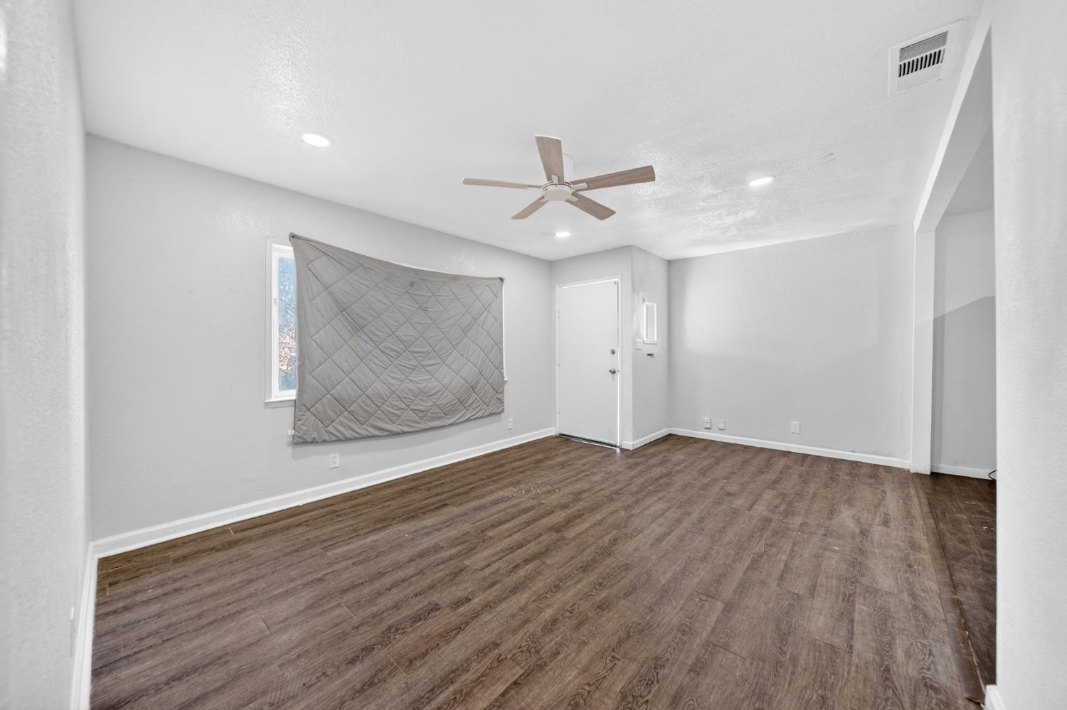 622 South 11th Street Fresno, CA 93702 - Photo 18 of 37 wooden floor in an empty room with a window
