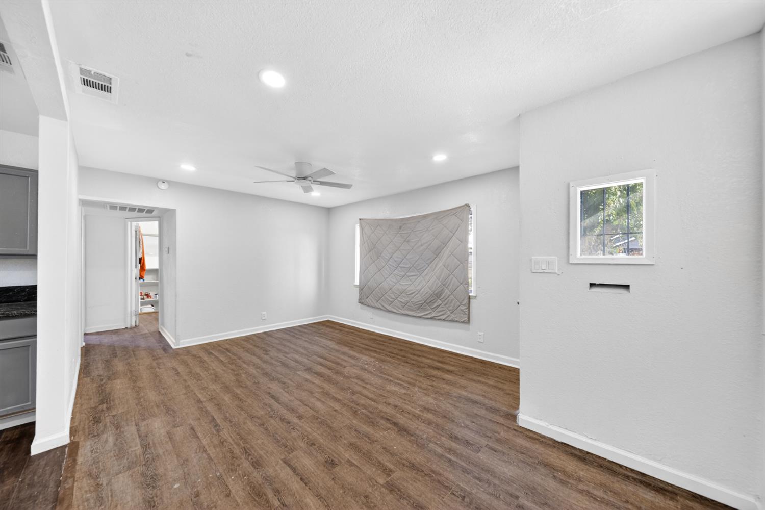 622 South 11th Street Fresno, CA 93702 - Photo 22 of 37 a view of an empty room with wooden floor and a window