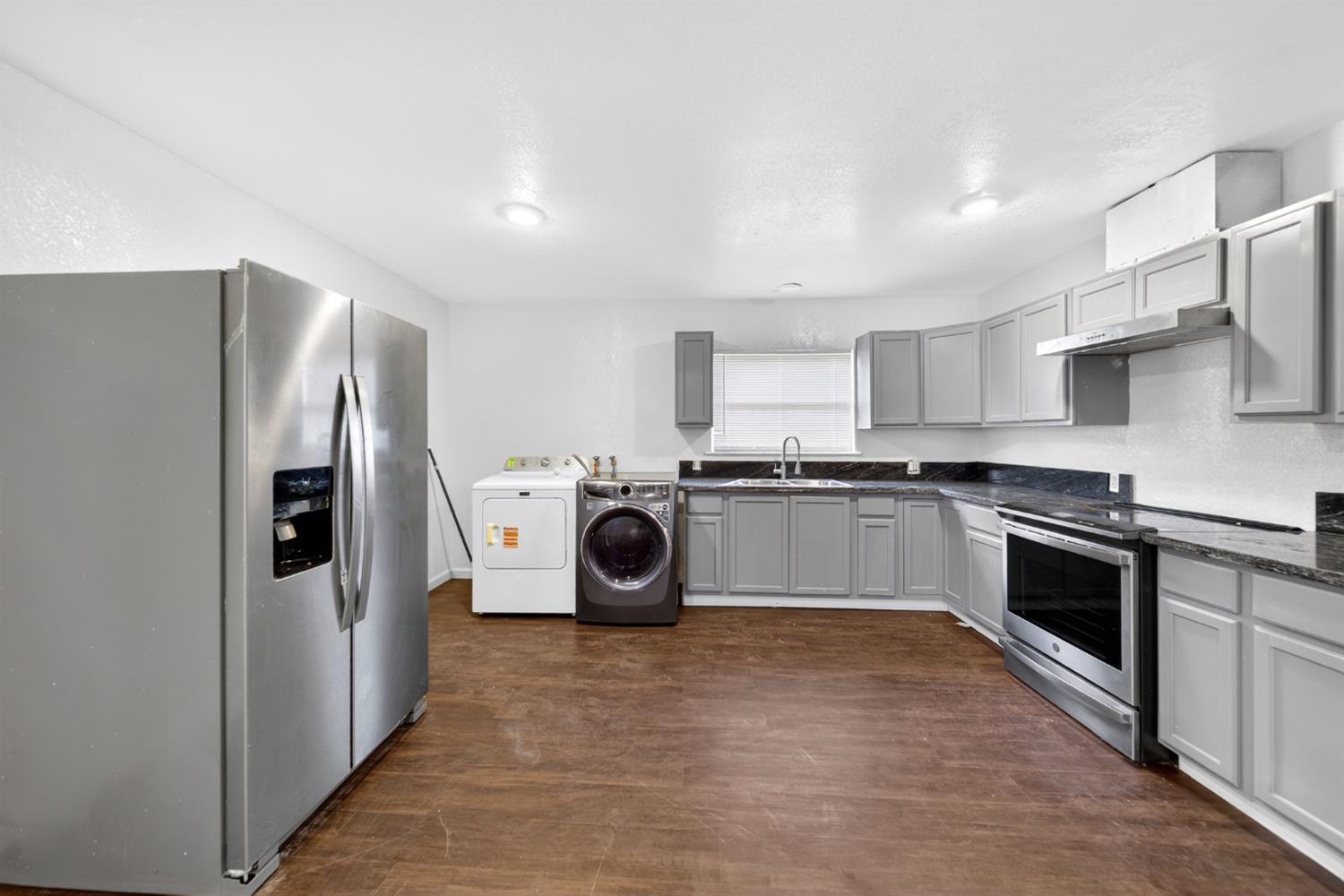 622 South 11th Street Fresno, CA 93702 - Photo 24 of 37 a kitchen with a refrigerator sink and stove top oven