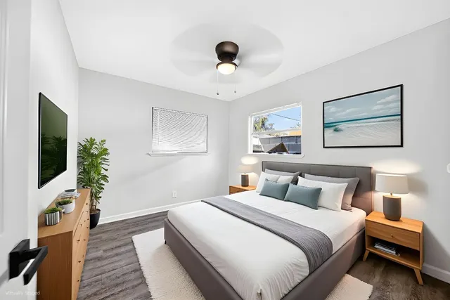 a bedroom with a bed and a flat screen tv