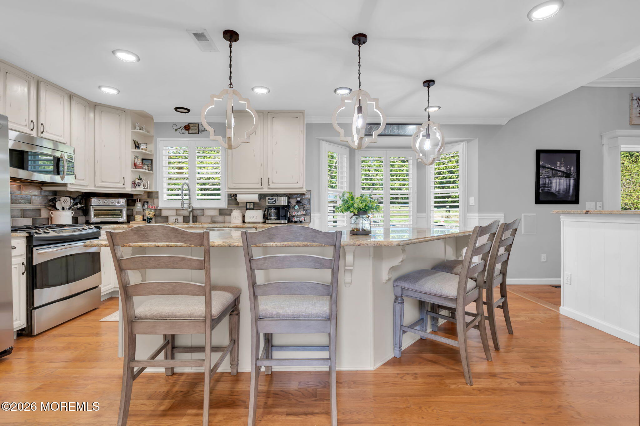 9 Eagle Ridge Lane West Creek, NJ 08092 - Photo 2 of 55 a kitchen with stainless steel appliances kitchen island granite countertop a stove a refrigerator a kitchen island with a dining table and chairs