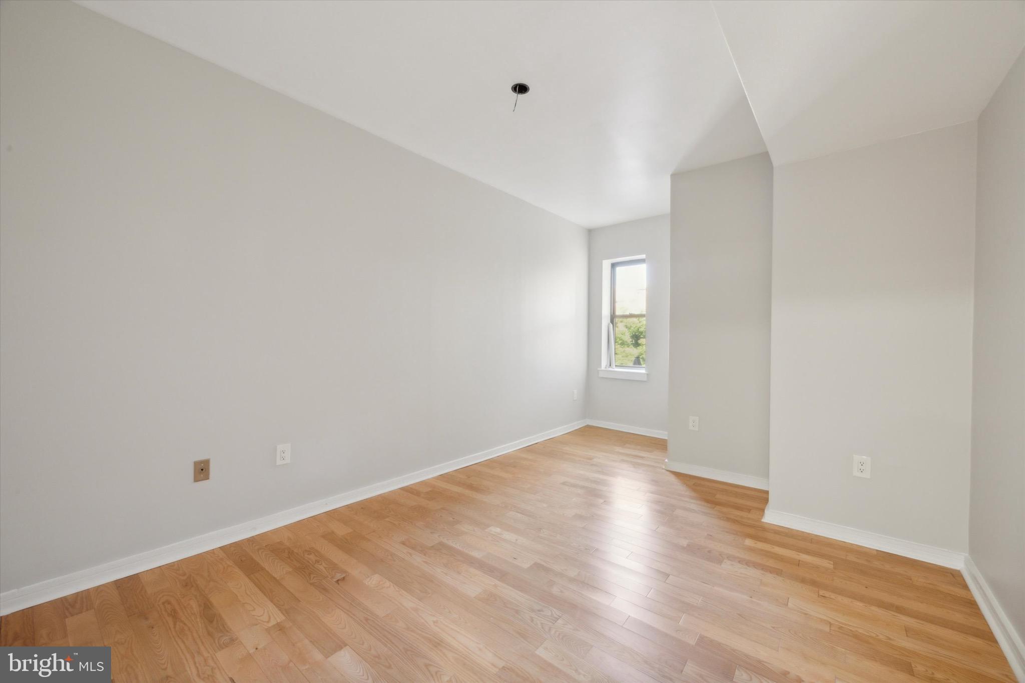 222 Church Street, Unit 3F Philadelphia, PA 19106 - Photo 11 of 19 a view of an empty room with wooden floor and a window