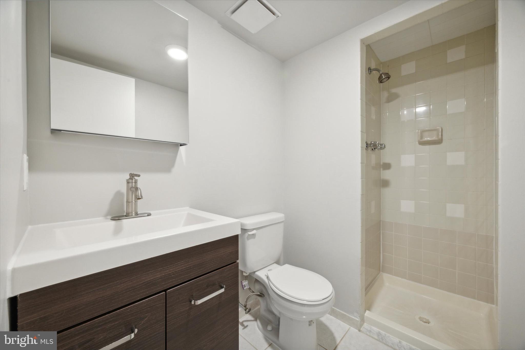 222 Church Street, Unit 3F Philadelphia, PA 19106 - Photo 13 of 19 a bathroom with a sink a toilet a shower and a mirror