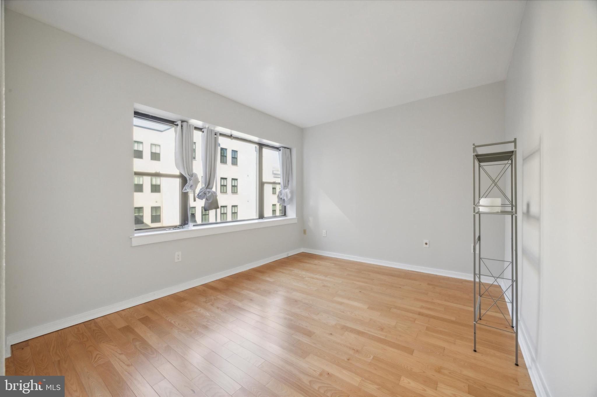 222 Church Street, Unit 3F Philadelphia, PA 19106 - Photo 14 of 19 a view of an empty room with wooden floor and a window