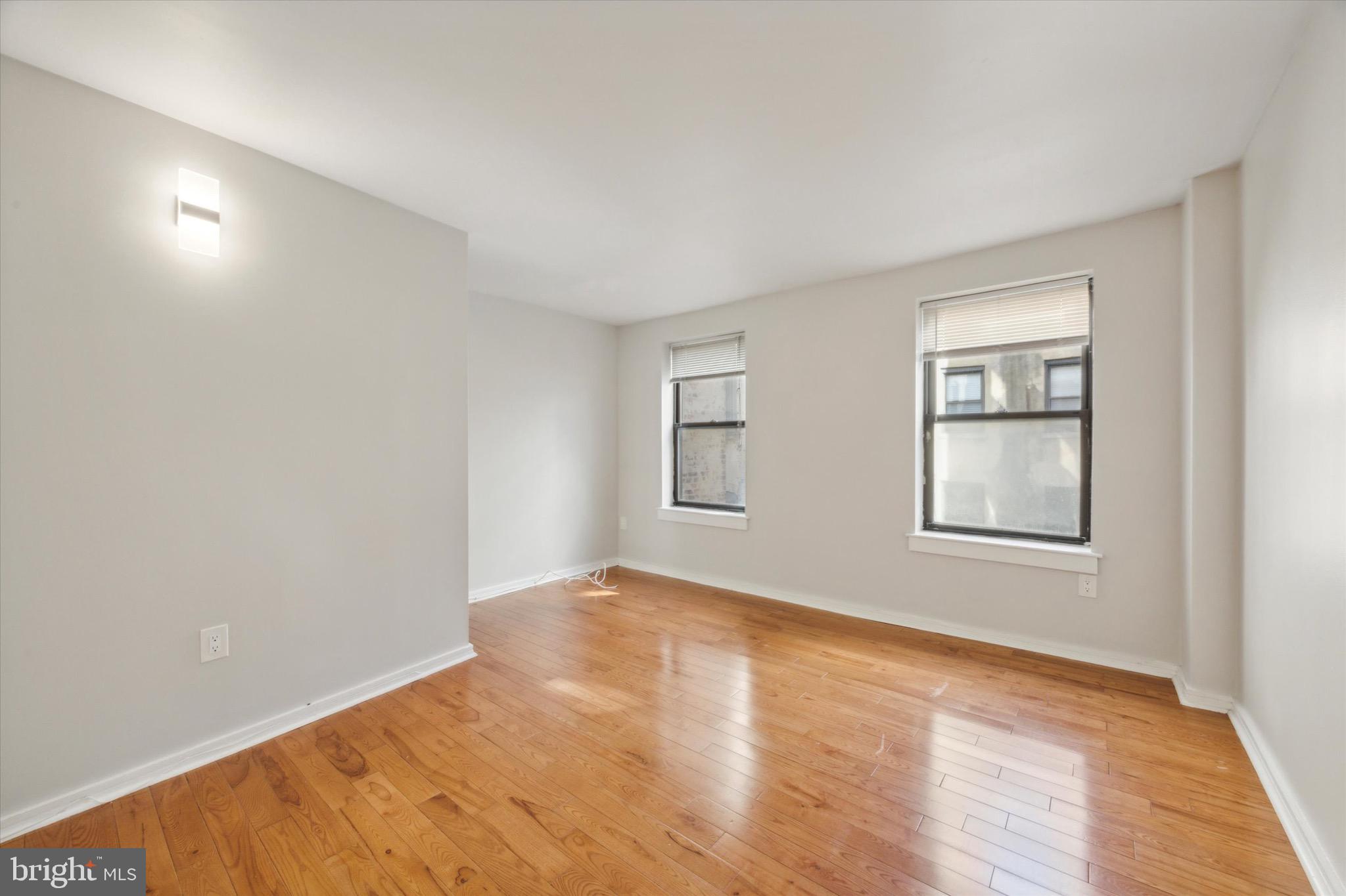 222 Church Street, Unit 3F Philadelphia, PA 19106 - Photo 15 of 19 a view of an empty room with wooden floor and a window